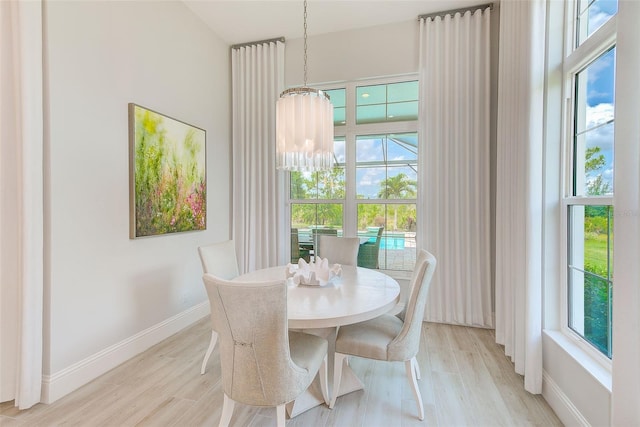 16707 Verona Pl, Bradenton, FL 34202 - dining area with light wood-type flooring and a chandelier