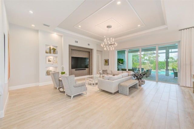 16707 Verona Pl, Bradenton, FL 34202 - living room featuring a tray ceiling, a chandelier, light wood-style flooring, and recessed lighting
