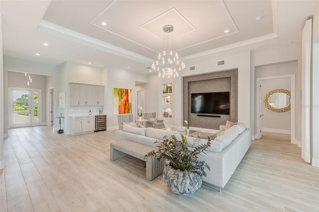 16707 Verona Pl, Bradenton, FL 34202 - living area featuring a raised ceiling, light wood-style flooring, recessed lighting, wine cooler, and a chandelier