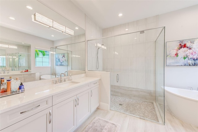 16707 Verona Pl, Bradenton, FL 34202 - full bath featuring a shower stall, a soaking tub, vanity, recessed lighting, and wood finished floors
