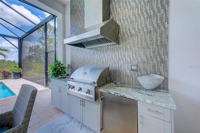 16707 Verona Pl, Bradenton, FL 34202 - view of patio with exterior kitchen, an outdoor pool, and a lanai