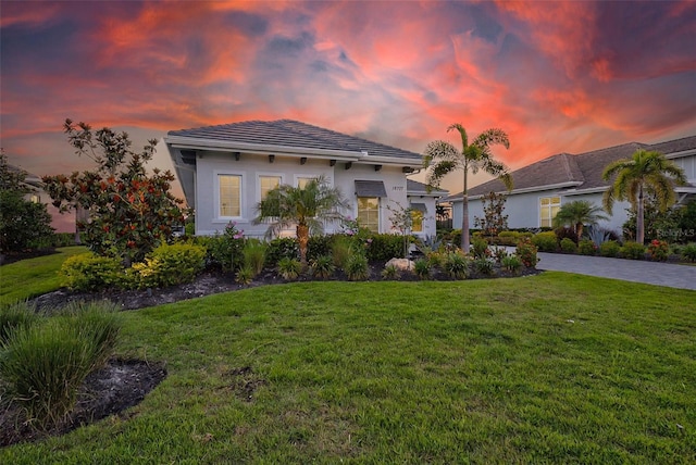 16707 Verona Pl, Bradenton, FL 34202 - view of front facade featuring a lawn, driveway, and stucco siding