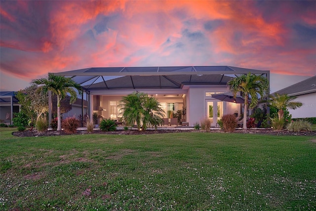 16707 Verona Pl, Bradenton, FL 34202 - back of house with a lawn, a lanai, a patio, and stucco siding