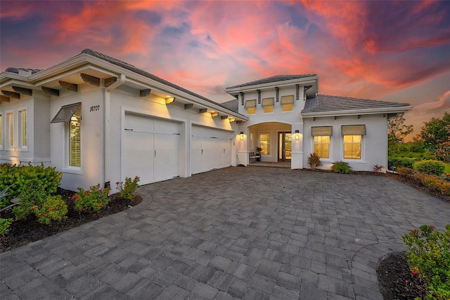 16707 Verona Pl, Bradenton, FL 34202 - view of front of home with a garage, decorative driveway, and stucco siding
