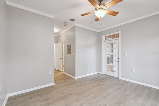 spare room with light wood-style floors, baseboards, crown molding, and a ceiling fan