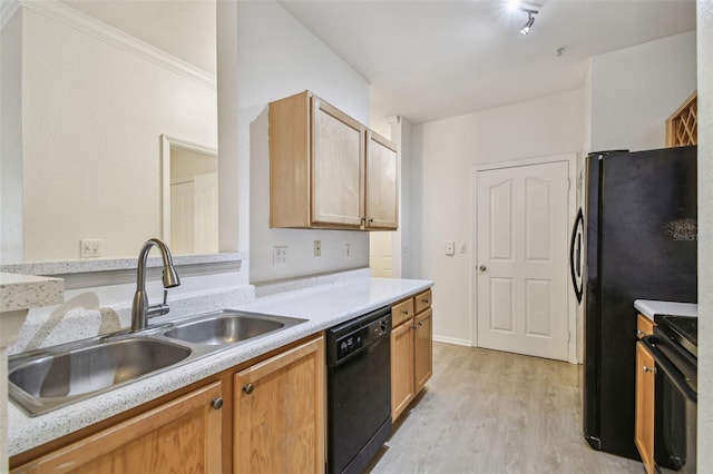 kitchen featuring black dishwasher, range, a sink, light wood-style flooring, and light countertops