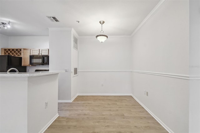 unfurnished dining area with light wood finished floors, baseboards, and crown molding