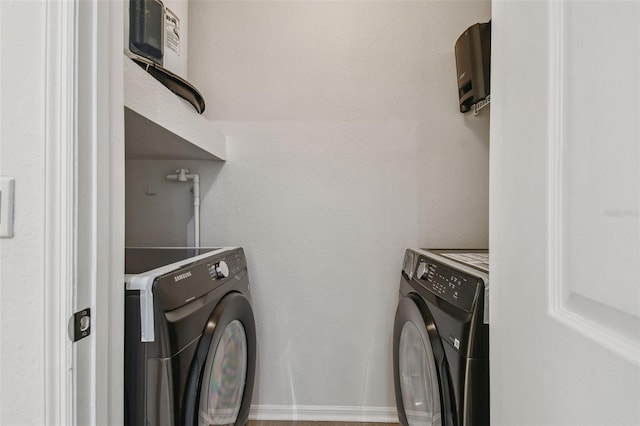 laundry area with washing machine and clothes dryer