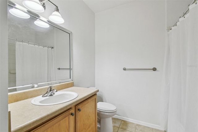 full bath with toilet, vanity, tile patterned floors, and baseboards