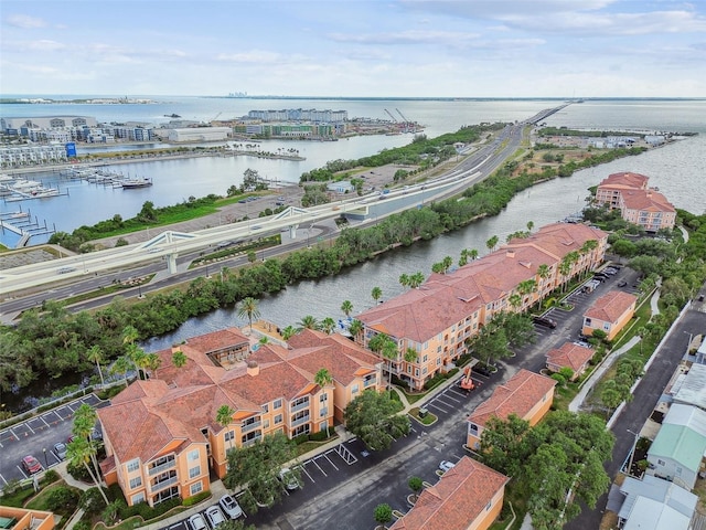 aerial view of property's location featuring a nearby body of water and apartment complex