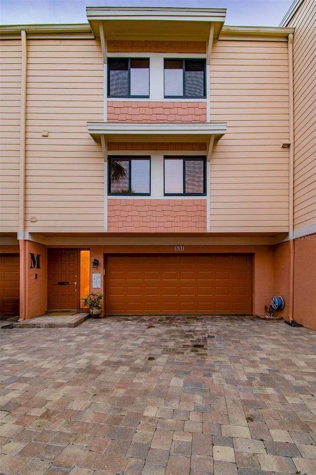 531 Sandy Hook Rd, Treasure Island, FL 33706 - multi unit property featuring a garage and decorative driveway