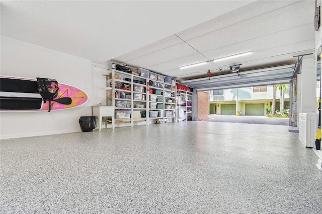 531 Sandy Hook Rd, Treasure Island, FL 33706 - garage with baseboards and a garage door opener