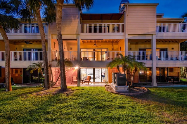 531 Sandy Hook Rd, Treasure Island, FL 33706 - rear view of property featuring a ceiling fan, a patio area, a yard, and a balcony