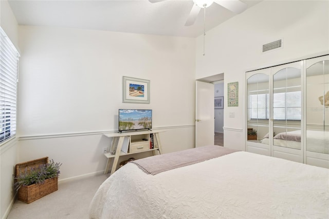 531 Sandy Hook Rd, Treasure Island, FL 33706 - carpeted bedroom with multiple windows, baseboards, a ceiling fan, a closet, and high vaulted ceiling