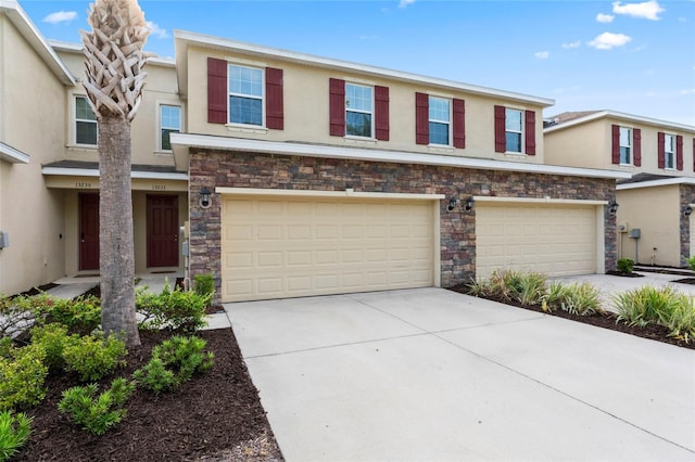 13233 Canopy Creek Dr, Tampa, FL 33625 - view of property with stucco siding, concrete driveway, a garage, and stone siding