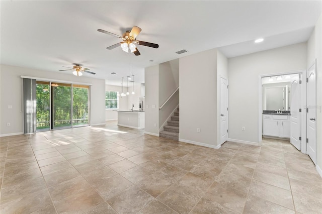 13233 Canopy Creek Dr, Tampa, FL 33625 - unfurnished living room featuring stairs, a ceiling fan, baseboards, recessed lighting, and a sink