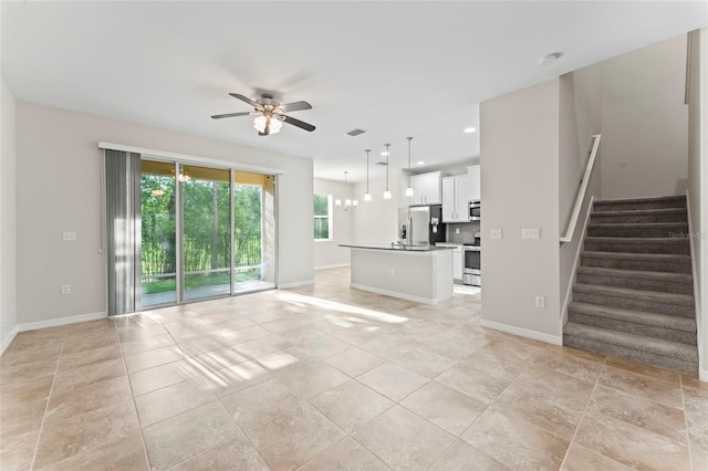 13233 Canopy Creek Dr, Tampa, FL 33625 - unfurnished living room with ceiling fan, stairway, baseboards, and recessed lighting