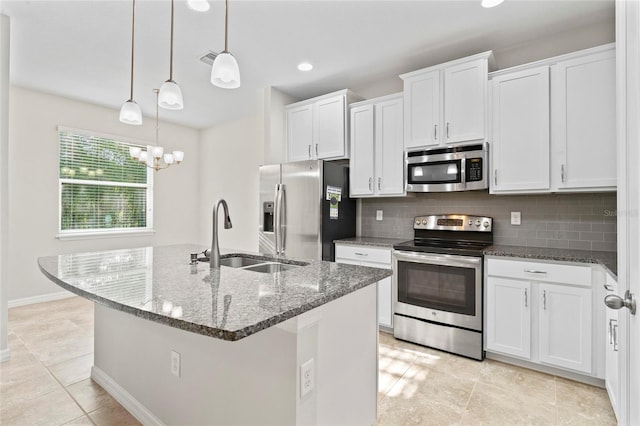 13233 Canopy Creek Dr, Tampa, FL 33625 - kitchen featuring stainless steel appliances, a sink, white cabinets, backsplash, and dark stone countertops