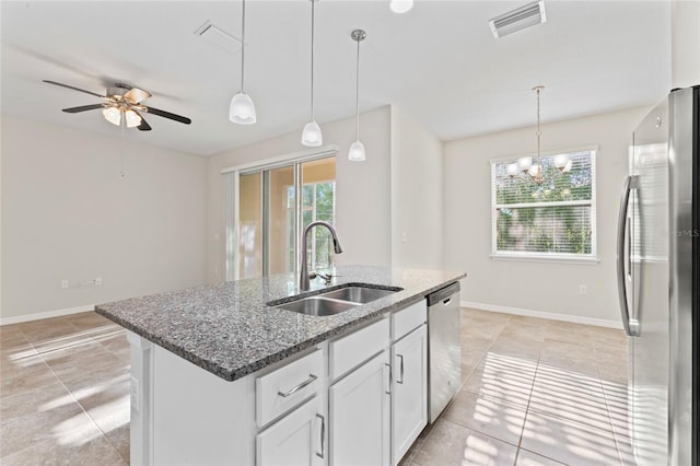 13233 Canopy Creek Dr, Tampa, FL 33625 - kitchen featuring appliances with stainless steel finishes, a sink, a kitchen island with sink, a ceiling fan, and white cabinets