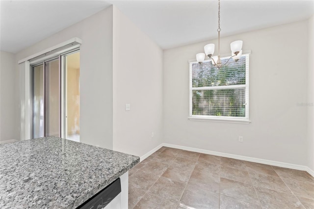 13233 Canopy Creek Dr, Tampa, FL 33625 - unfurnished dining area with a chandelier, baseboards, and light stone finish floors