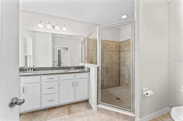 13233 Canopy Creek Dr, Tampa, FL 33625 - bathroom featuring a stall shower, double vanity, baseboards, and toilet
