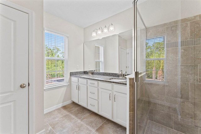13233 Canopy Creek Dr, Tampa, FL 33625 - full bath with a shower stall, baseboards, double vanity, and tile patterned flooring