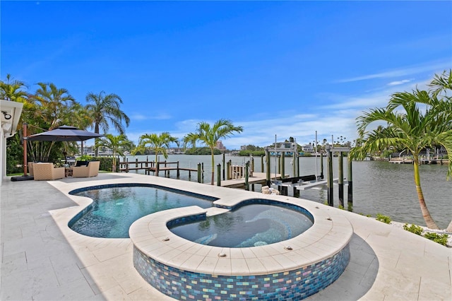 243 Hermosita Dr, St Pete Beach, FL 33706 - view of swimming pool with boat lift, a water view, a boat dock, a pool with connected hot tub, and a patio area