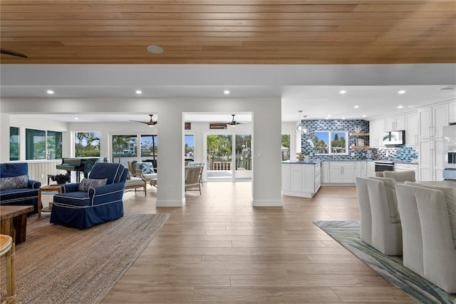 243 Hermosita Dr, St Pete Beach, FL 33706 - living area with ceiling fan, plenty of natural light, wood ceiling, recessed lighting, and light wood-style flooring