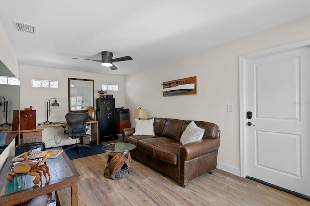 243 Hermosita Dr, St Pete Beach, FL 33706 - living room featuring a ceiling fan, light wood-style floors, a desk, and baseboards