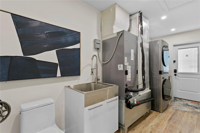 243 Hermosita Dr, St Pete Beach, FL 33706 - utility room with stacked washer and clothes dryer and a sink