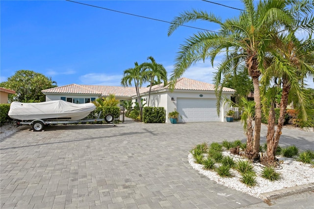 243 Hermosita Dr, St Pete Beach, FL 33706 - single story home featuring a tile roof, stucco siding, a garage, decorative driveway, and fence