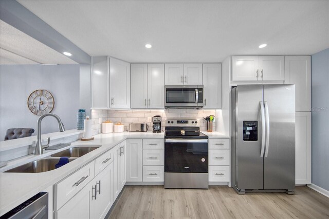 15000 Gulf Blvd Unit 602, Madeira Beach, FL 33708 - kitchen with appliances with stainless steel finishes, a sink, light wood-style floors, light countertops, and recessed lighting