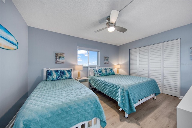 15000 Gulf Blvd Unit 602, Madeira Beach, FL 33708 - bedroom with wood finished floors, a textured ceiling, a ceiling fan, and a closet