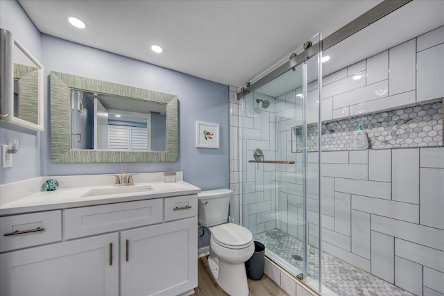 15000 Gulf Blvd Unit 602, Madeira Beach, FL 33708 - full bathroom with a shower stall, toilet, wood finished floors, vanity, and recessed lighting