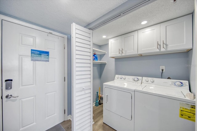 15000 Gulf Blvd Unit 602, Madeira Beach, FL 33708 - washroom featuring cabinet space, a textured ceiling, washer and dryer, light wood-style flooring, and recessed lighting