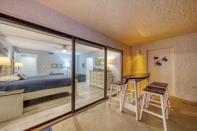 15000 Gulf Blvd Unit 602, Madeira Beach, FL 33708 - bedroom featuring a textured wall, finished concrete flooring, a textured ceiling, and a closet