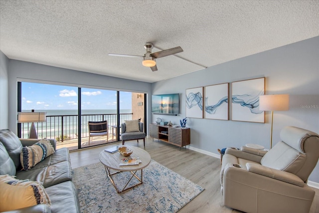 15000 Gulf Blvd Unit 602, Madeira Beach, FL 33708 - living room with ceiling fan, a textured ceiling, wood finished floors, and baseboards