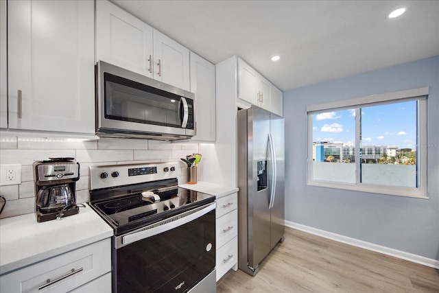 15000 Gulf Blvd Unit 602, Madeira Beach, FL 33708 - kitchen with stainless steel appliances, baseboards, decorative backsplash, light wood-style floors, and recessed lighting
