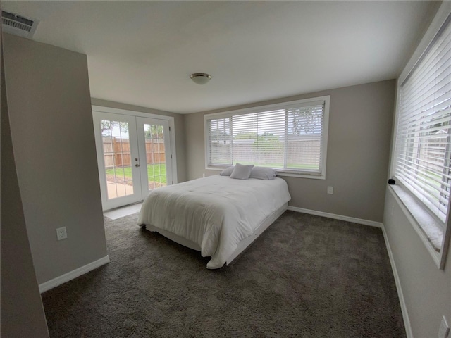 carpeted bedroom with access to outside, french doors, and baseboards
