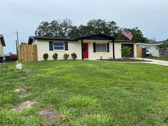 12907 College Hill Dr, Hudson, FL 34667 - ranch-style house with central AC unit, an attached garage, and driveway