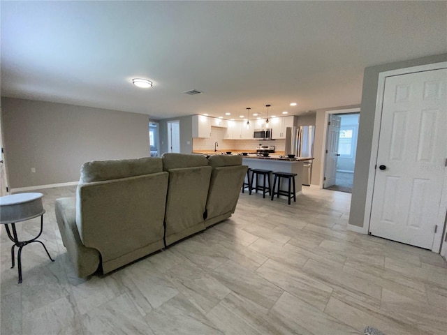 12907 College Hill Dr, Hudson, FL 34667 - living area featuring recessed lighting and baseboards