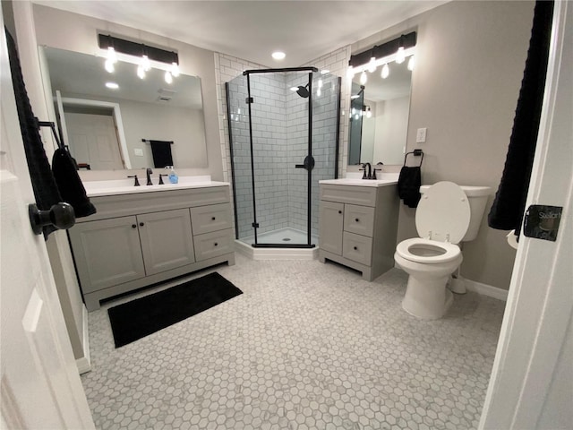 12907 College Hill Dr, Hudson, FL 34667 - bathroom with a shower stall, two vanities, toilet, baseboards, and tile patterned flooring