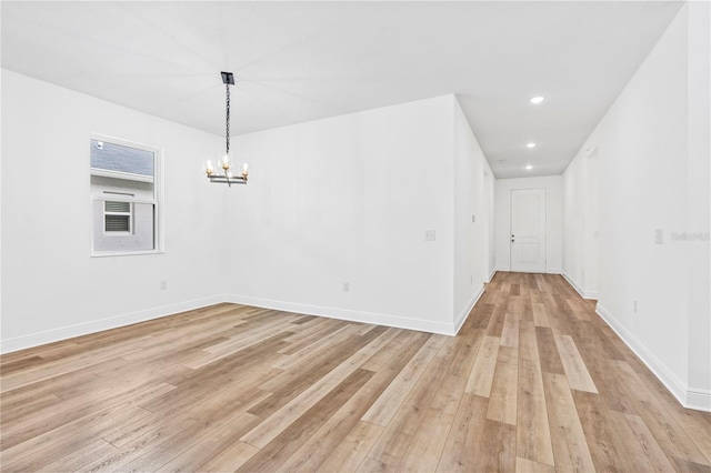 unfurnished dining area featuring light wood-style flooring, a chandelier, recessed lighting, and baseboards