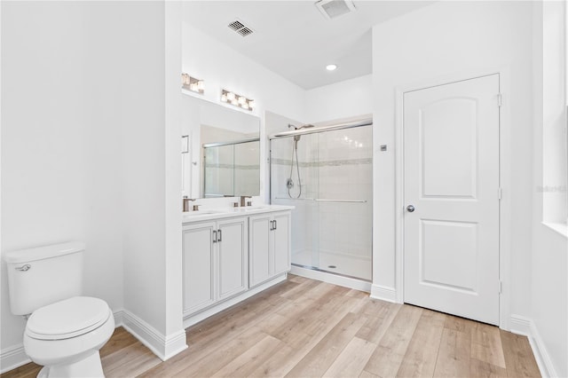 full bath featuring a shower stall, wood finished floors, toilet, baseboards, and recessed lighting