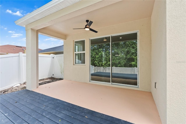 deck featuring a patio, fence, and ceiling fan