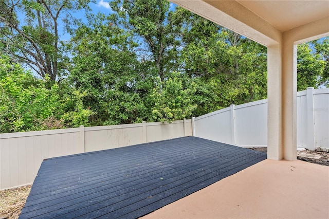deck with a fenced backyard