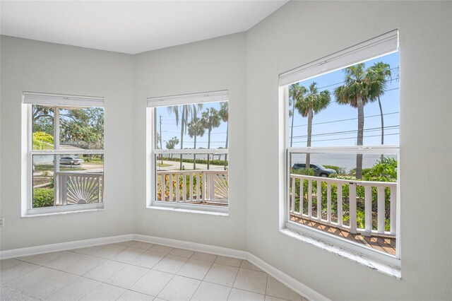 401 Whitcomb Blvd, Tarpon Springs, FL 34689 - empty room with baseboards and light tile patterned floors
