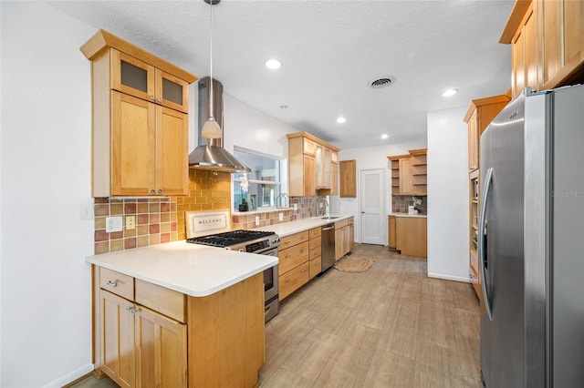 401 Whitcomb Blvd, Tarpon Springs, FL 34689 - kitchen featuring appliances with stainless steel finishes, open shelves, a sink, a peninsula, and backsplash