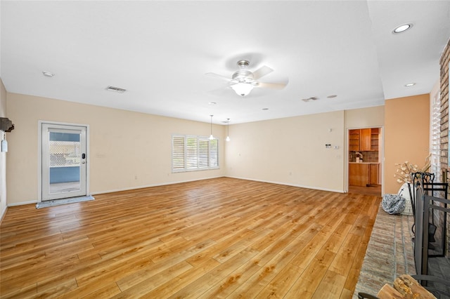401 Whitcomb Blvd, Tarpon Springs, FL 34689 - unfurnished living room featuring light wood-style flooring, ceiling fan, baseboards, and recessed lighting