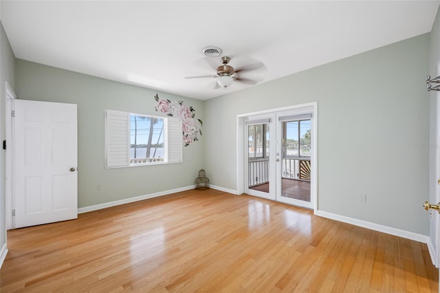 401 Whitcomb Blvd, Tarpon Springs, FL 34689 - unfurnished room with plenty of natural light, a ceiling fan, french doors, and baseboards